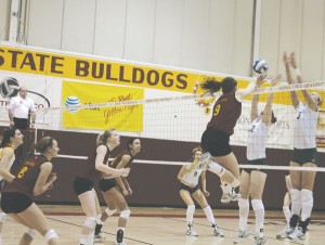 Flying High: Senior Sarah Lark spikes the ball over opponents during a recent game.  The volleyball team will travel to Indianapolis on the 19th for the first round of NCAA D-II Midwest Region games. Photo By: Kate Dupon | Photgrapher
