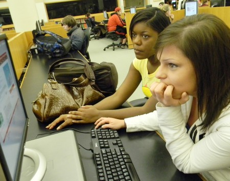 Differential Graduation Rates: Ivana Hill (Left) and Tina Marie Sobel (Right) work in the library. Ferris State has been shown to have one of the largest graduation gaps between black and white students. The graduation rate from 2006-08 was 40.2 percent for while students and 15.9 percent black students. Photo By: Angela Walukonis | Photographer