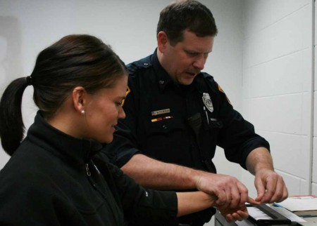 Officers Against Terror: Officer Saunders fingerprints a Wisconsin teaching student. Ferris State will begin to train officers from across the state to recognize signs of terrorist activity and learn how to react quickly. Photo By: Kate Dupon | Photo Editor