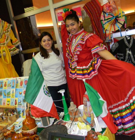 All Around the World: Ferris hospitality student, Mariana Garcia and Grand Rapids resident, Nancy Ramos show their heritage. The International Festival was held to showcase the various cultures from around the world and educate students about different foods, dances and traditions. Photo By: Angie Walukonis | Photographer