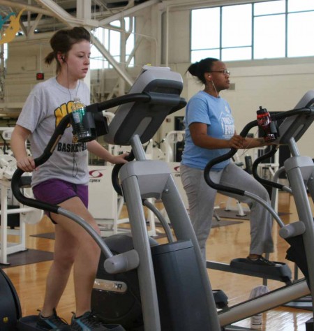 Shape Up: Samantha Krause and Keisha Reynolds, above, work out at the University Recreation Center. The URec is just one of many places students can work out during the summer in Big Rapids. Photo By: Kate Dupon | Photo Editor