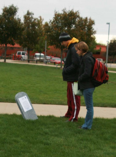 Domestic Abuse Awareness: Ferris students Kendra Sondgrass and Elliot Anderson read stories that are apart of the Tombstone Project that is located in North Quad.  Photo By: Kate Dupon | Photo Editor