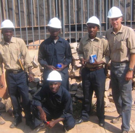 Professor Experience: Ferris manufacturing engineering techology professor Bruce Gregory (far right) traveled to Kuito, Angola, Africa. Gregory helped to train local men on how to drill water wells. Photo Courtesy of Bruce Gregory