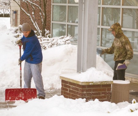Cleaning Up: Ferris student employees work to clean off sidewalks and salt them after a snowstorm. Photos By: Eric Trandel | Photographer