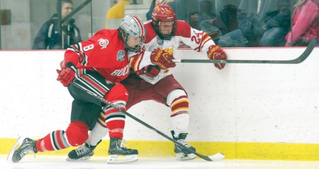 Down for the Count: Sophomore center Dom Panetta gets checked into the boards against Ohio State during a game at Ewigleben Ice Arena. The Bulldogs were unsuccessful on the road to come out on top of a three-game series to earn a spot for the CCHA Championship. Photo By: Brock Copus | Multimedia Editor