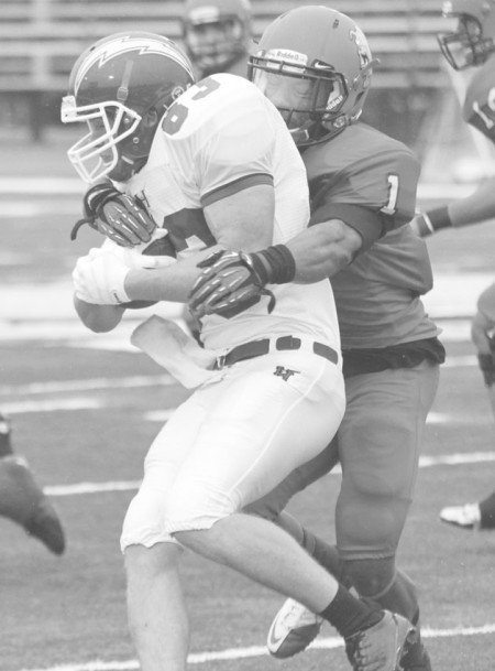 Bringing Down the House: Bulldog senior Jamar Slade tackles a Hillsdale Charger from last season. Slade is currently eyeing a career as a professional football player after he graduates from Ferris. Photo By: Brock Copus | Multimedia Editor