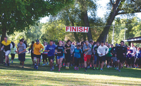 Coming Together: Students, staff and members of the community particiapte in a 5k run/walk at Hemlock Park to help raise money for a new free pharmacy clinic in Big Rapids. Photo By: Eric Trandel | Photo Editor