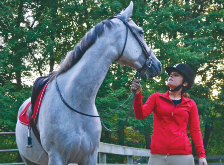 Katherine Petermann, sophomore in criminal justice, works with her horse Rogan as part of the equestrian team at Ferris. Photo By: Olivia Odette | Photographer 