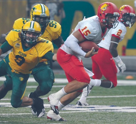 Challenging the Champs: Ferris sophomore quarterback Jason Vander Laan eludes a North Dakota State tackle during Saturday’s game. Ferris lost to FCS Champion North Dakota State 56-10 and is now preparing to face Lake Erie Collegef or the start of Great Lakes Intercollegiate Athletic Conference play. Courtesy Photo By: Dennis Hubbard
