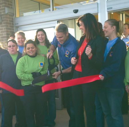 Manager Dean Quiggle cuts the ribbon marking the opening of the new Aldi grocery store in Big Rapids, located at 21481 Perry Ave. The store offers a variety of grocery products at a low price. Photo By: Taylor Hooper | News Writer