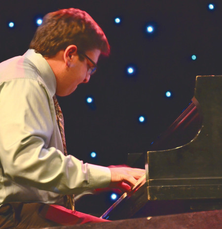 Doug Reed plays the piano during the Jazz Band Fall Concert on Nov. 13 in the Williams auditorium, with the theme of music by Miles Davis. Reed has been playing the piano for 15 years and draws influence from such artist as Elvis, BB King and Ray Charles. Photo By: Olivia Odette | Photographer