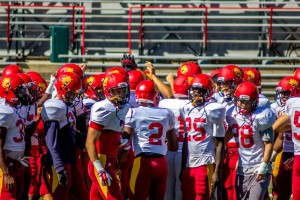 Ferris State football’s defense gathers in the middle of the field following  a team scrimmage  during one of the Bulldogs padded practices.