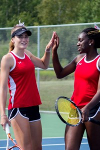 Shawnee-Ann Breisford and Noelly Long Nsimba congratulate eachother following a won point in a doubles match.