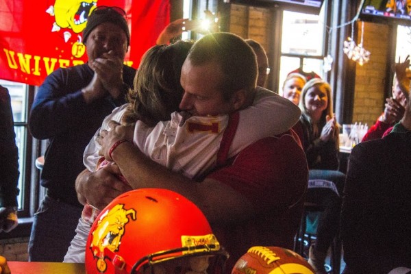 Junior quarterback Jason Vander Laan hugs his mother Cindy