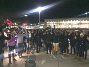 Members of the Black Student Union with their hands up at the Eric Garner Rally held on campus.
