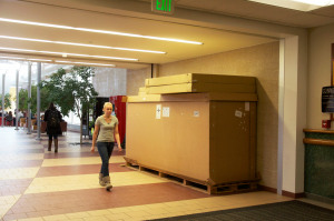 Marketing junior Ashley Soller walks by the box that has been mysteriously placed inside the IRC, where it has been since the first semester, apparently untouched.