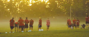 The women’s soccer team practices for the upcoming season just as dawn breaks in this photo taken last fall.