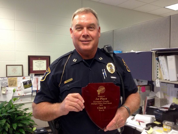 Captain Jim Cook holds his first place plaque from a recent Michigan Police Pistol Match.