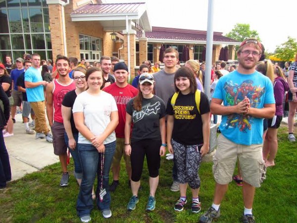 Freshmen students pose for a group photo with their new peer mentor. 