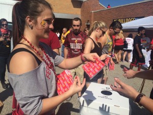 News Services employees Jordan House tosses out FERR1S merchandise at a recent Ferris football game.
