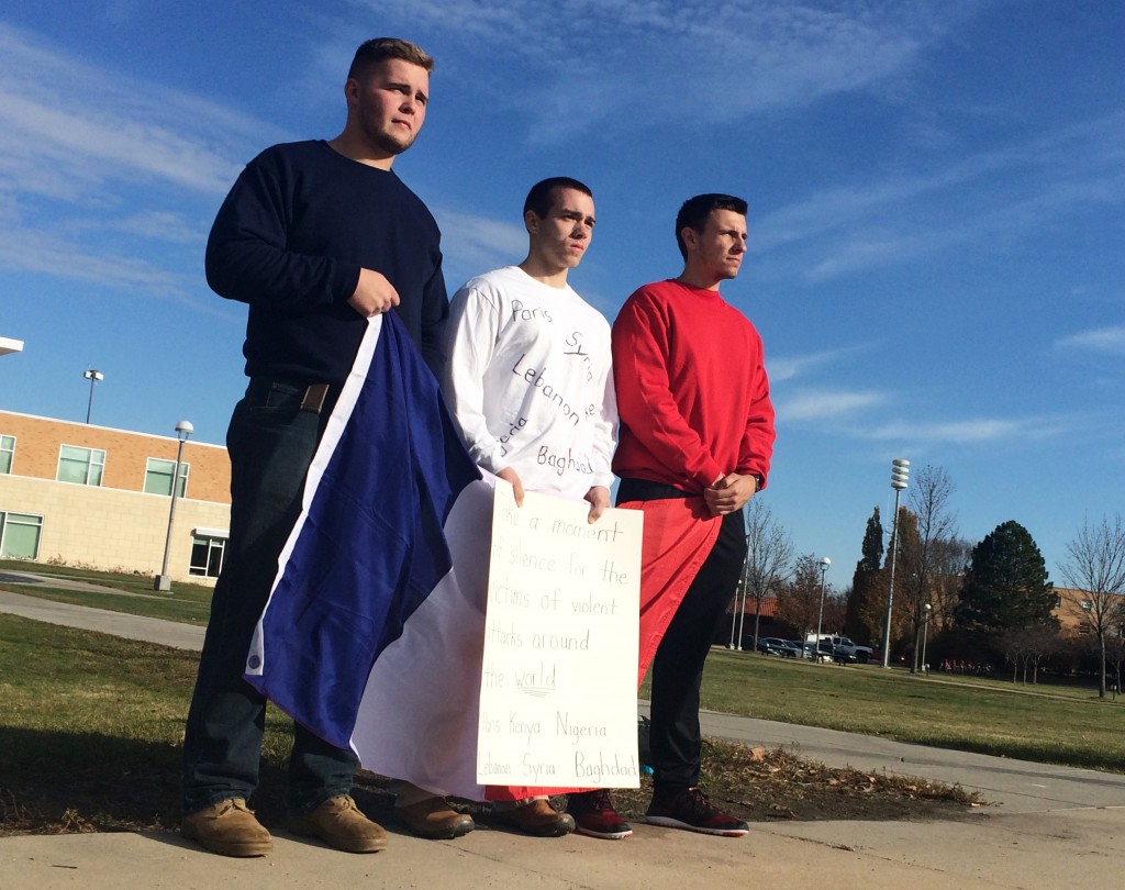 Travis Hill, Michael Leech and Kyle Flite wear the French colors in the quad to show support for victims of recent attacks in France and across the world.