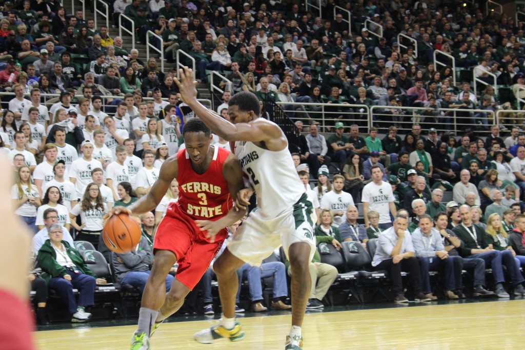 Senior guard Josh Fleming takes the ball to the basket against Michigan State’s Javon Bess in an exhibition earlier this season.