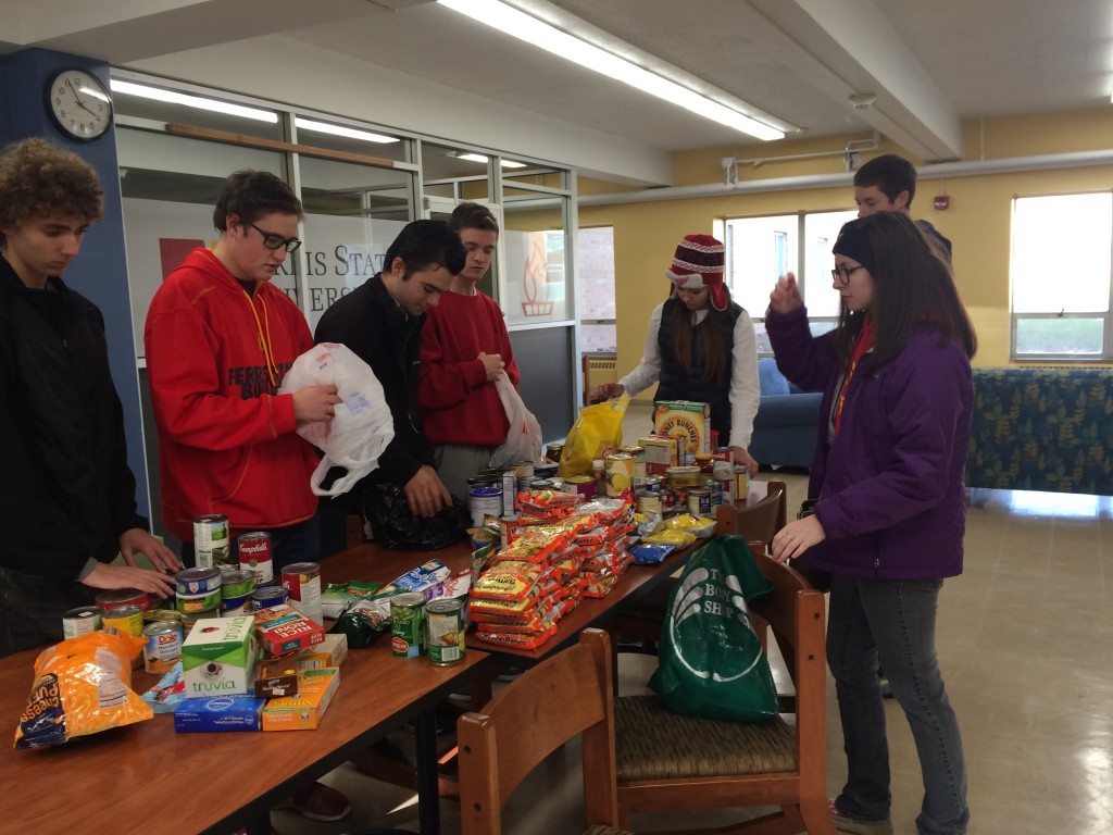 The yellow tribe unloads some of the food items that they collected. Students collected more than 1,400 items to donate to Manna Pantry in Big Rapids.