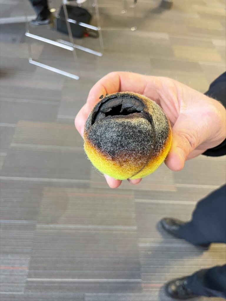 A tennis ball caught fire