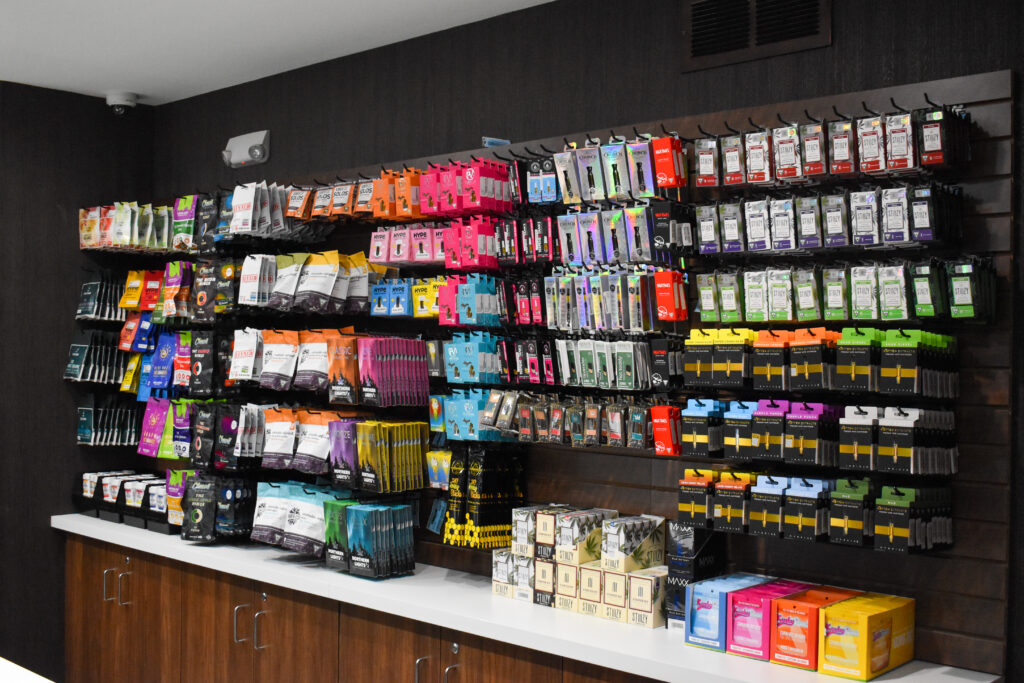 Pictured are wall-mounted rack filled with product inside the High Society dispensary.